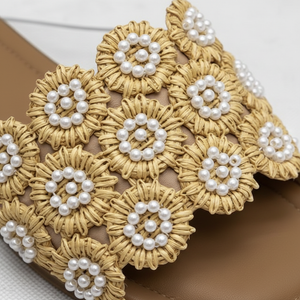 Tavo Nude Pearl Flower Raffia Flat Slide Sandals – macro close-up of golden raffia flower rosettes with white pearl bead centres