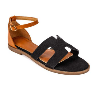 Edmond Black Suede H-Strap Flat Sandals – product shot showing black suede H-strap upper with tan leather ankle strap and gold buckle on warm tan leather footbed