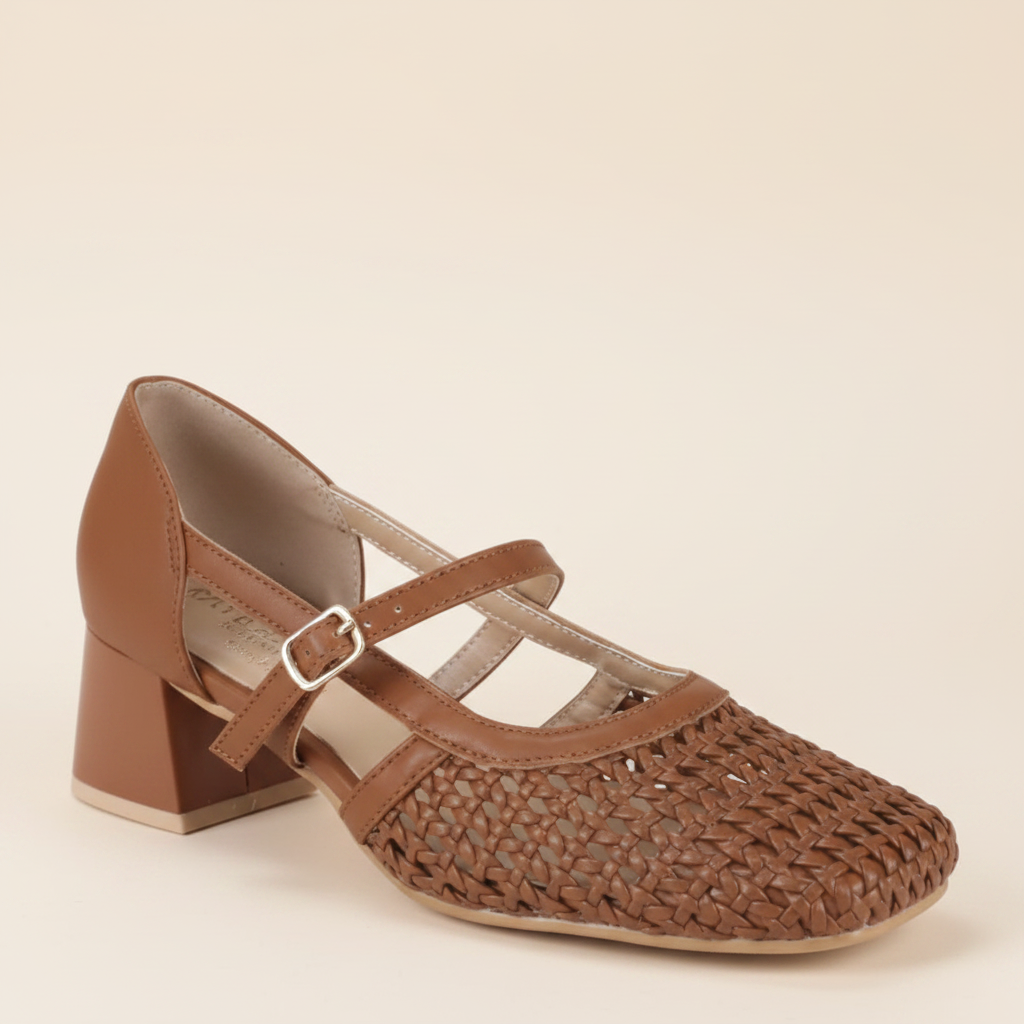 Close-up profile of woven tan Mary Jane shoe with gold buckle⠋