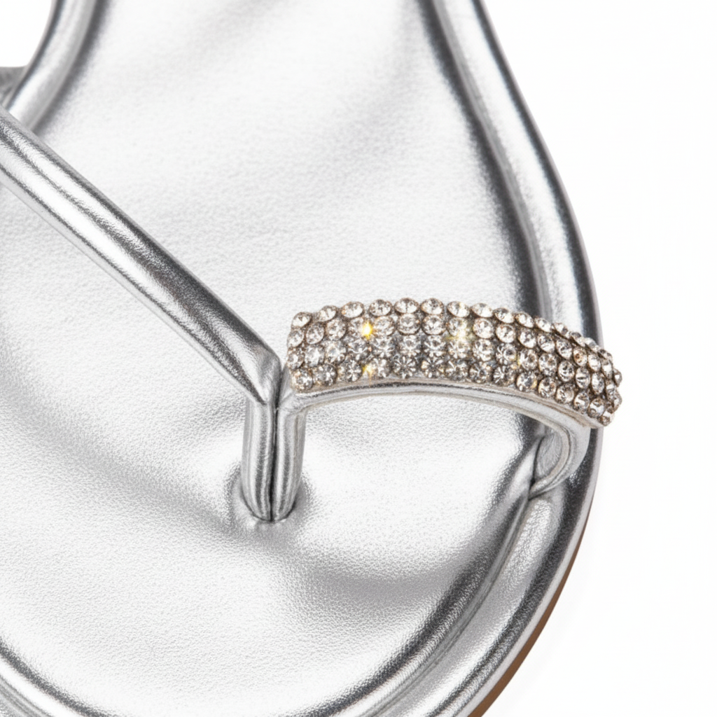 Nora Silver Metallic Crystal Toe Ring Flat Sandals – macro close-up of pavé crystal rhinestone toe ring on silver metallic strap