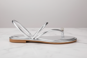 Nora Silver Metallic Crystal Toe Ring Flat Sandals – side profile view on white marble