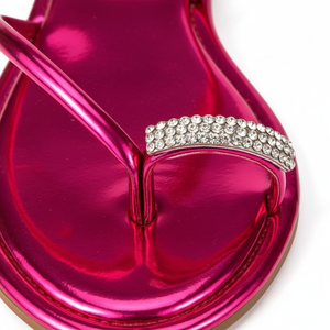 Nora Fuchsia Metallic Crystal Toe Ring Flat Sandals – macro close-up of pavé crystal rhinestone toe ring on fuchsia metallic strap