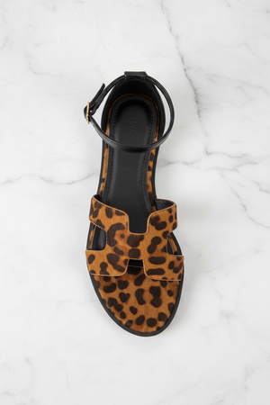 Edmond Leopard Print H-Strap Flat Sandals – top-down overhead view showing full sandal on white marble