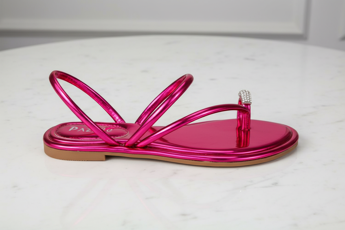 Nora Fuchsia Metallic Crystal Toe Ring Flat Sandals – side profile view on white marble