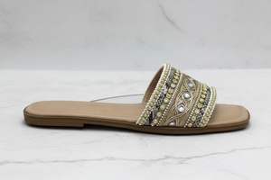 Zuri Nude Gold Embroidered Crystal Flat Slide Sandals – side profile view on white marble