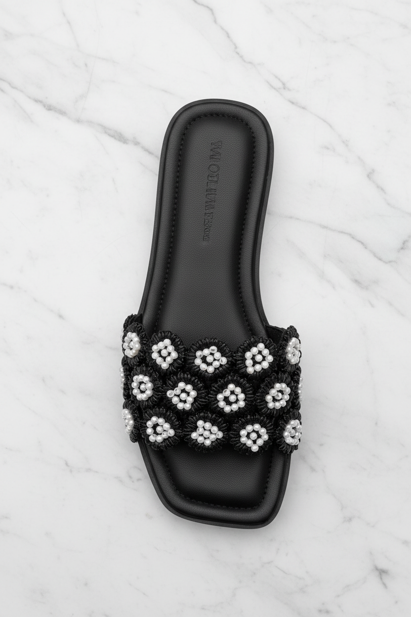 Tavo Black Pearl Flower Flat Slide Sandals – top-down overhead view showing full sandal on white marble