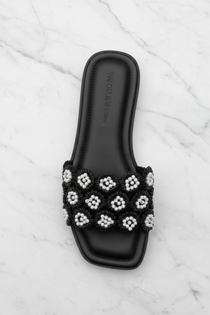 Tavo Black Pearl Flower Flat Slide Sandals – top-down overhead view showing full sandal on white marble