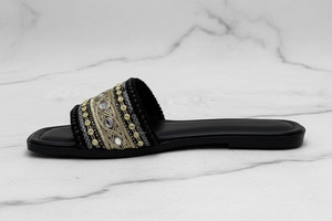 Black Gold Embroidered Crystal Flat Slide Sandals – side profile view on white marble