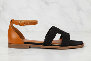 Edmond Black Suede H-Strap Flat Sandals – side profile view on white marble showing H-strap and ankle strap