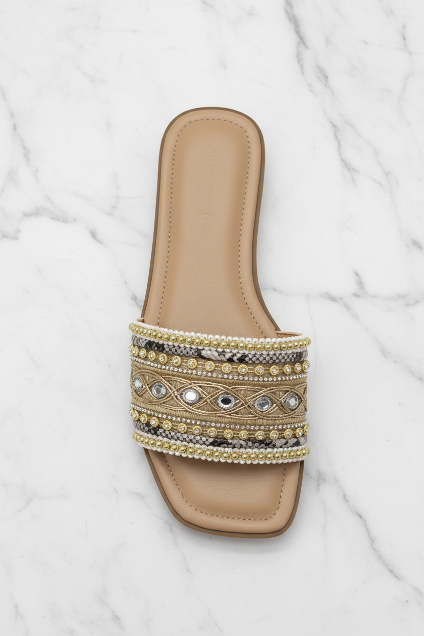 Zuri Nude Gold Embroidered Crystal Flat Slide Sandals – top-down overhead view showing full sandal on white marble