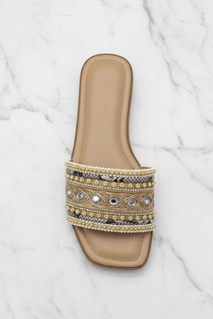 Zuri Nude Gold Embroidered Crystal Flat Slide Sandals – top-down overhead view showing full sandal on white marble