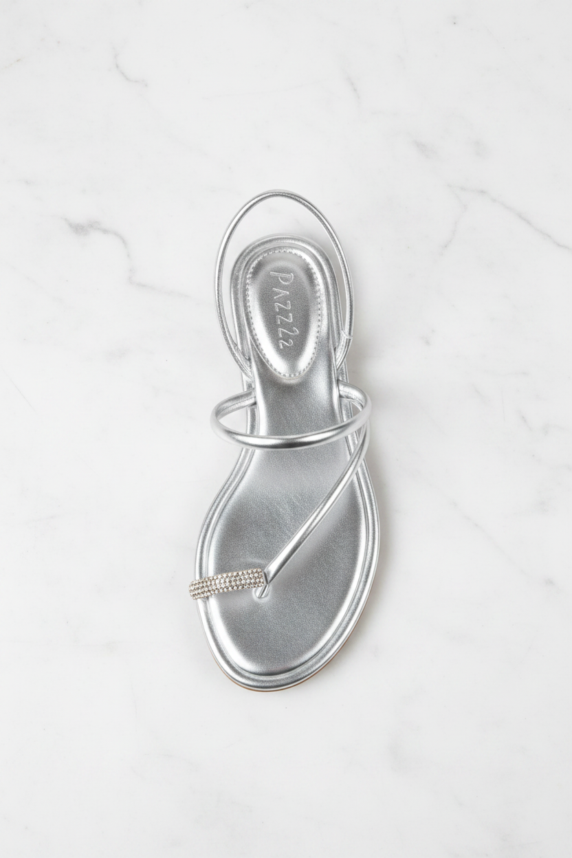 Nora Silver Metallic Crystal Toe Ring Flat Sandals – top-down overhead view showing full sandal on white marble