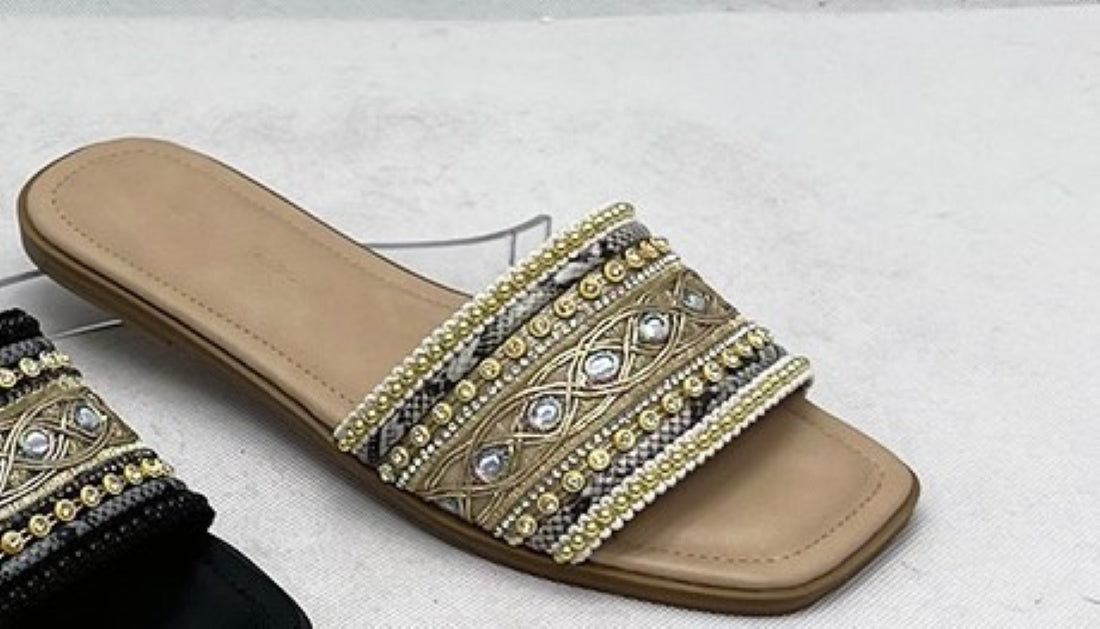 Zuri Nude Gold Embroidered Crystal Flat Slide Sandals – product shot showing taupe woven upper with gold metallic embroidery, crystal mirror jewels and gold bead rows on warm tan footbed