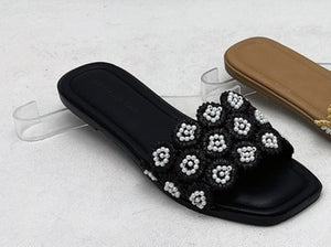 Tavo Black Pearl Flower Flat Slide Sandals – product shot showing black woven upper with 3D pearl flower rosette embellishments
